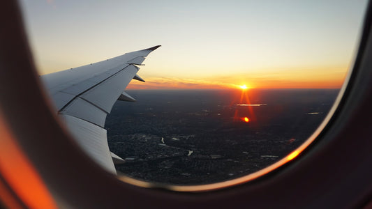 Traveler using smartphone at airport – comparing eSIM providers for international travel